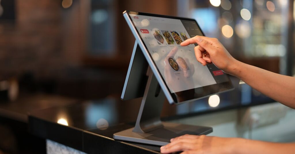 A Close-Up Shot of a Cashier Using a Point of Sale System